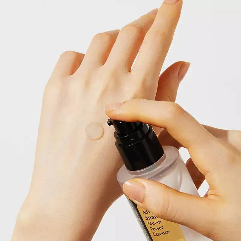 Iris Essentials snail serum collagen facial serum clear gel applied on hand with pump bottle