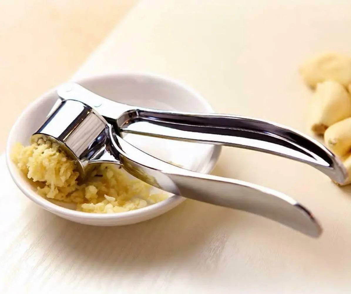 Ergonomic kitchen tool displayed with garlic peeler and clove  